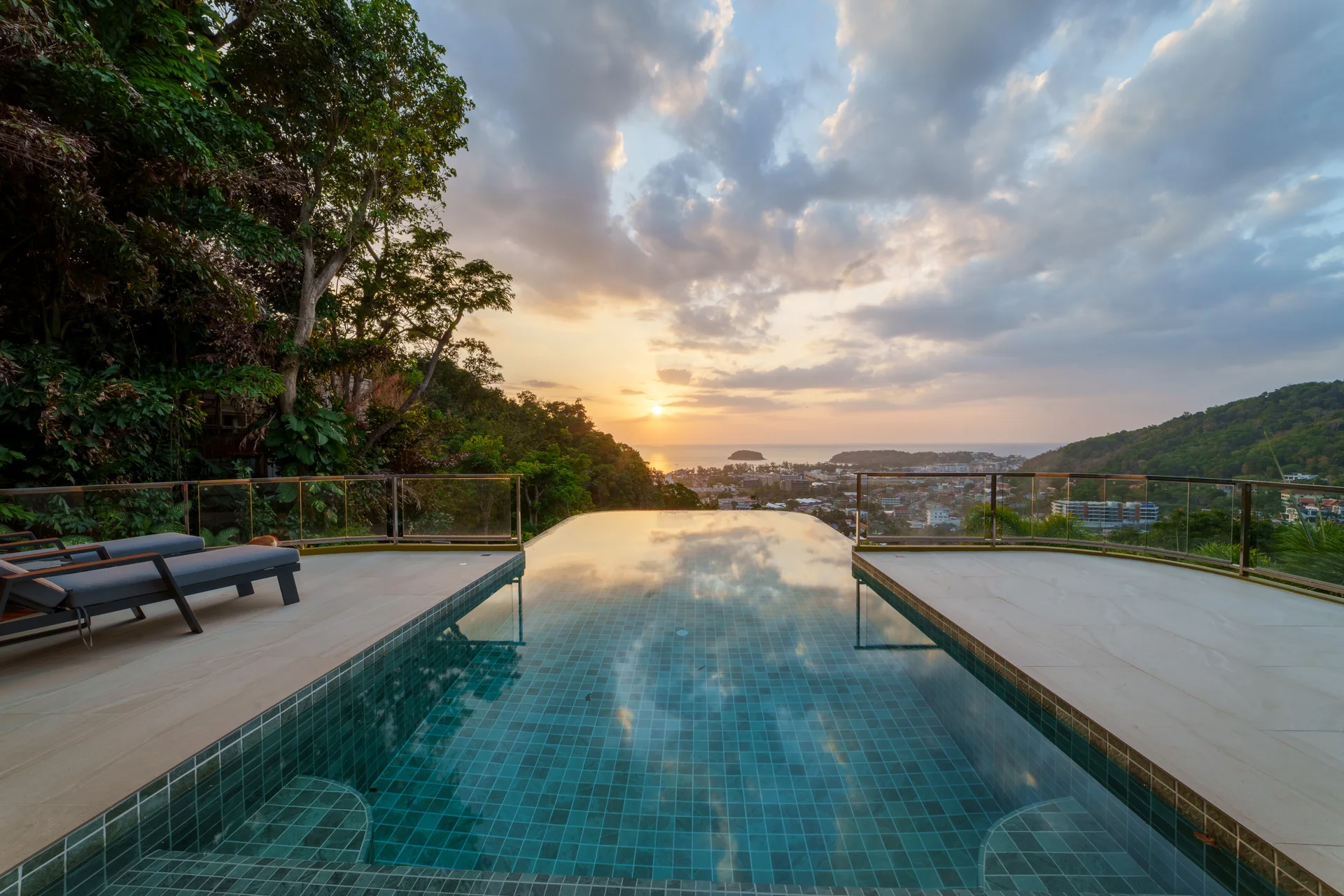 Sunset over the infinity pool and Kata Bay at Villa 18